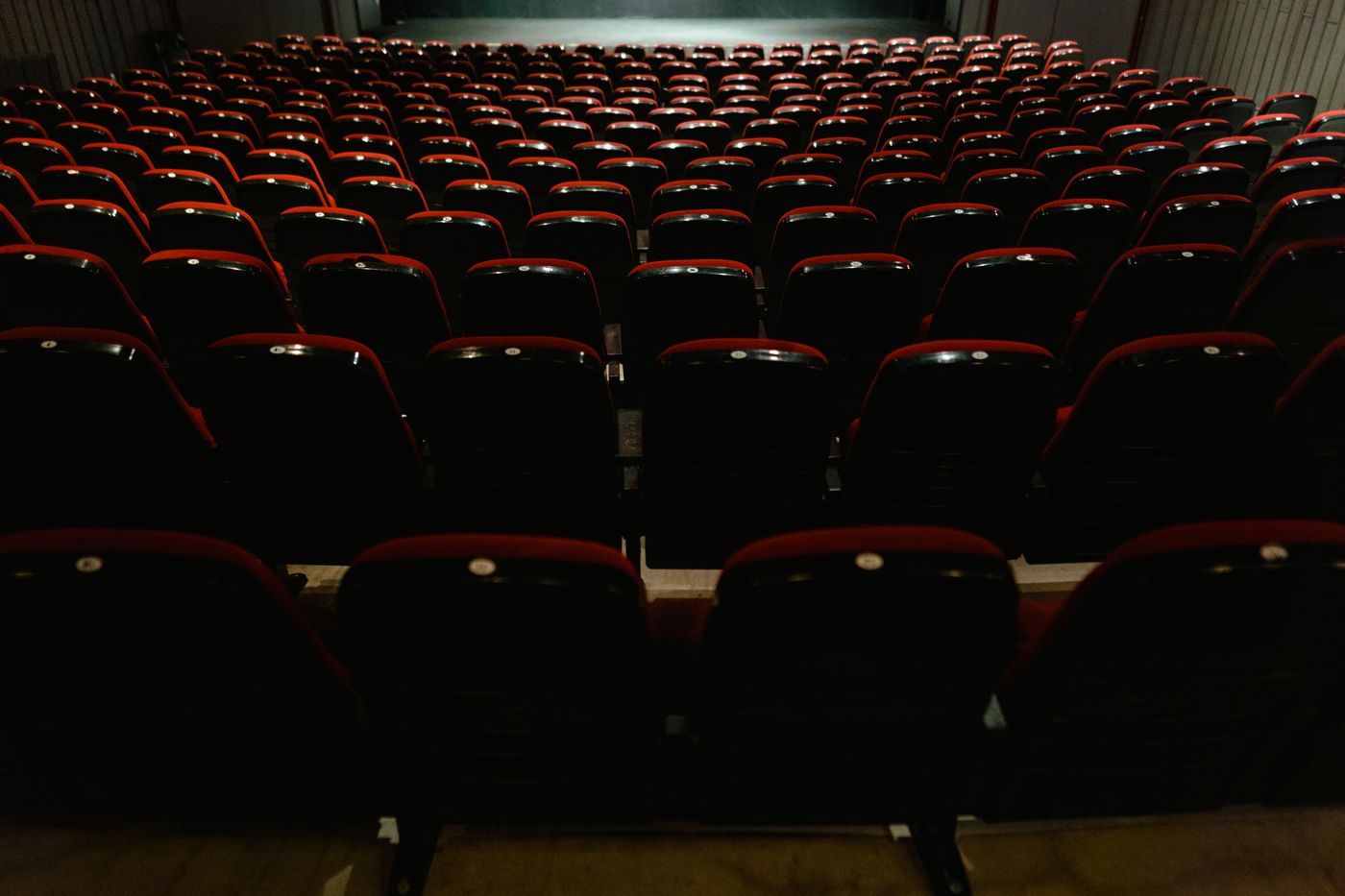 Empty rows of red and black cinema seats